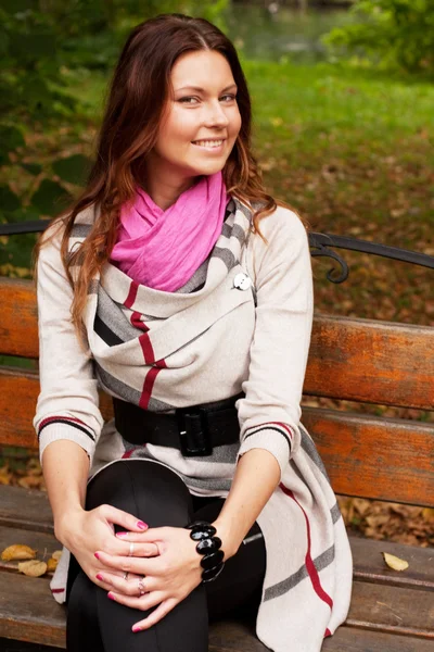 Girl on bench in autumn park