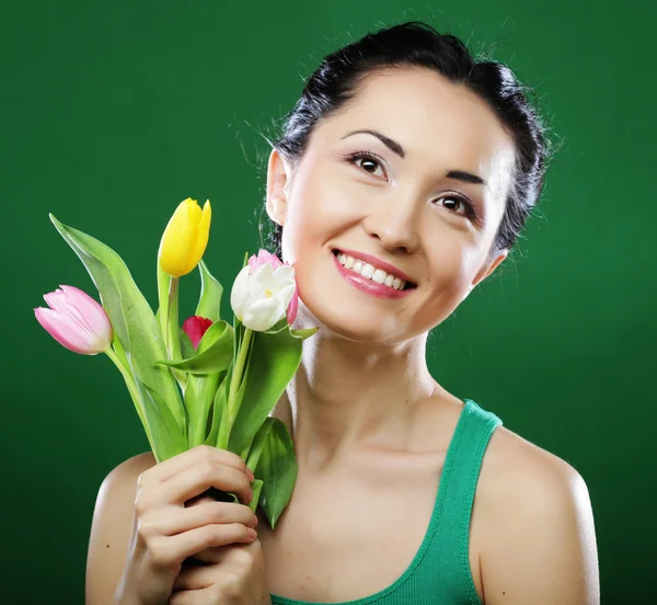 Young asian woman holding a bouquet of tulips