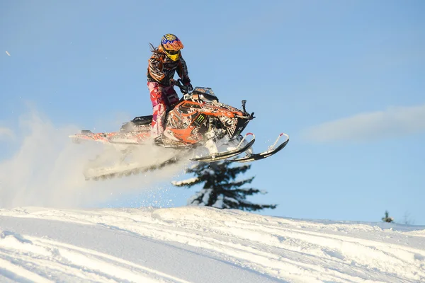 Snowmobile in winter forest in the mountains of Sakhalin Island