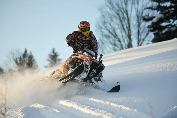 Snowmobile in winter forest in the mountains of Sakhalin Island