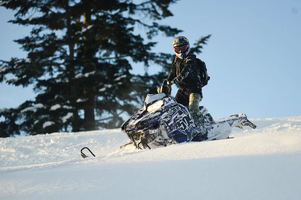 Snowmobile in winter forest in the mountains of Sakhalin Island