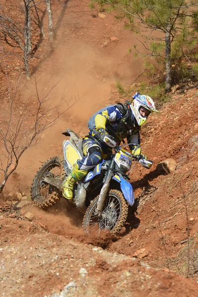 Enduro motorcycles descend from the steep slope on the mountain