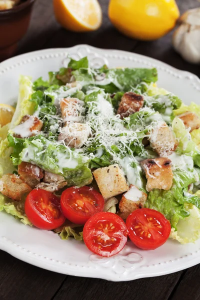 Caesar salad with lemon and cherry tomato