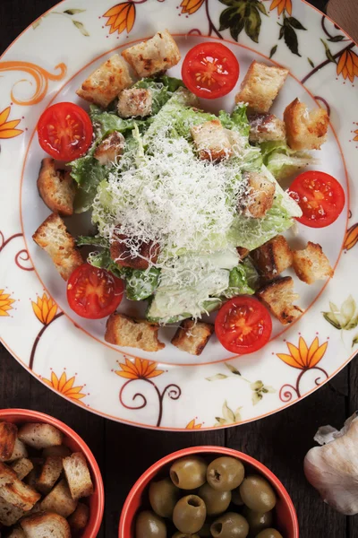 Caesar salad with croutons and cherry tomato