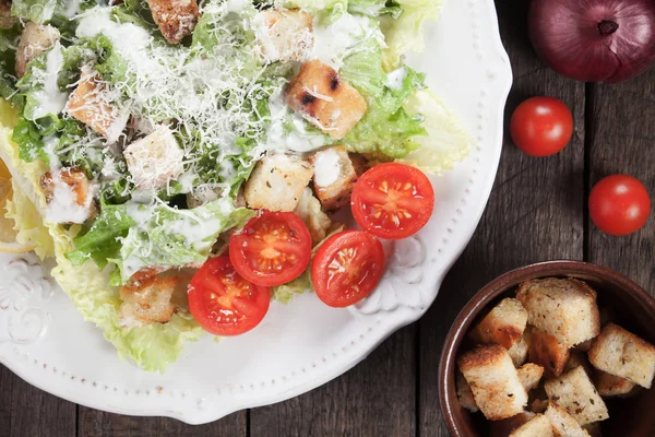 Caesar salad with croutons and cherry tomato