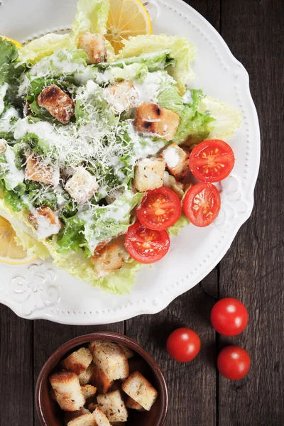 Caesar salad with croutons and cherry tomato