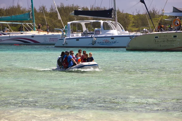 Tourists are transported by the small boat from a catamaran on Gabrielle\'s island on April 24, 2012 in Mauritius.