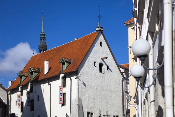 Tallinn, building of the 17th century in the old city and flags with the coats of arms of the ancient cities of the Hanseatic union