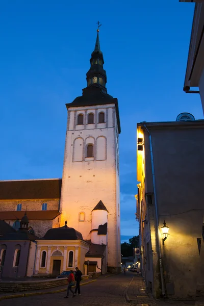 Old city, Tallinn, Estonia. Old houses on the street and a town hall tower.