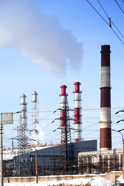 Pipe with smoke and line of electricity transmission on background