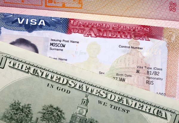 The American visa on page of the  international passport and US dollar