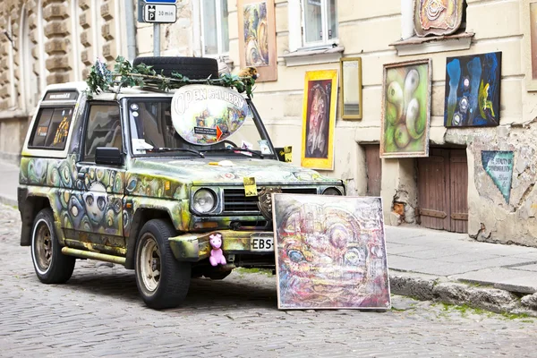 TALLINN, ESTONIA- JUNE 16: Brightly decorated  car advertizes an input in art gallery in the Old city on June 16, 2012 in Tallinn, Estonia