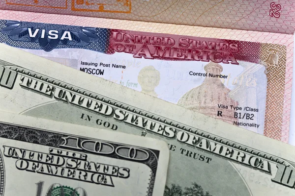 American visa on page of the Russian international passport and US dollars