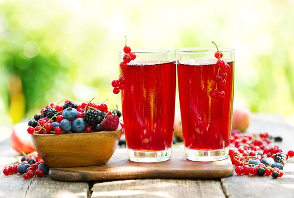 Glasses of fresh fruit drinks with fresh berries