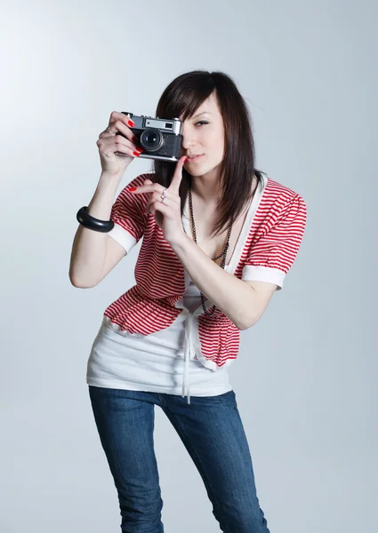 Young beautiful girl with retro camera