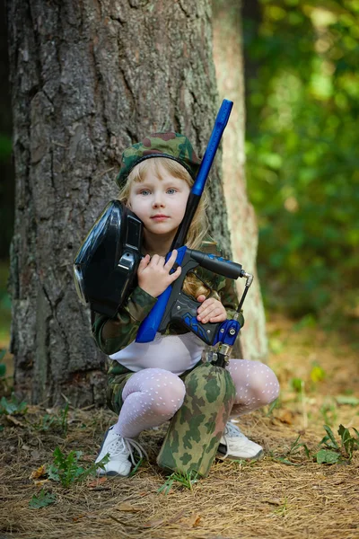 Girl in camouflage suit with rifle