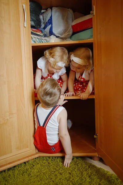 Little boy plays with twins
