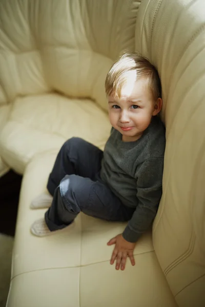 Little boy sitting on couch