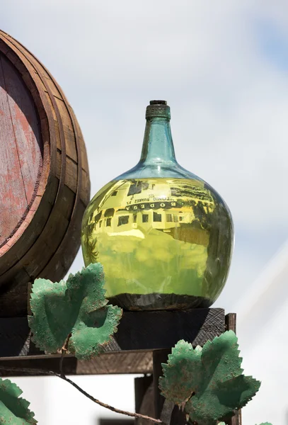 Barrels and  big bottles with grape wine - malvasia.  Lanzarote, Spain