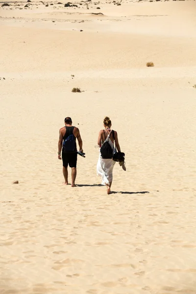 Couple walking on famous sand dunes of Fuerteventura. Canary Island, Spain