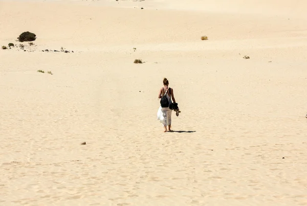 Woman walking on famous sand dunes of Fuerteventura. Canary Island, Spain