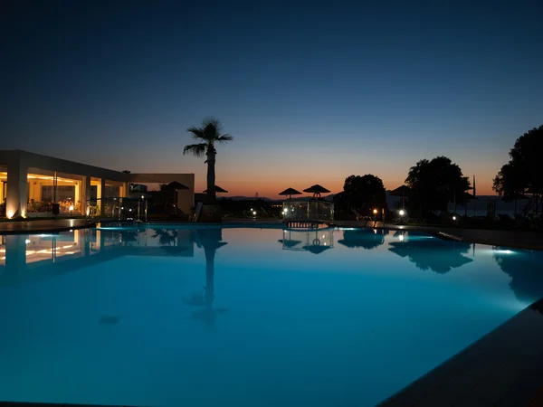 Swimming pool of luxury hotel at dusk