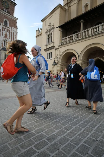 Pilgrims of World Youth Day sing and dance on the Main Square in  Cracow. Poland