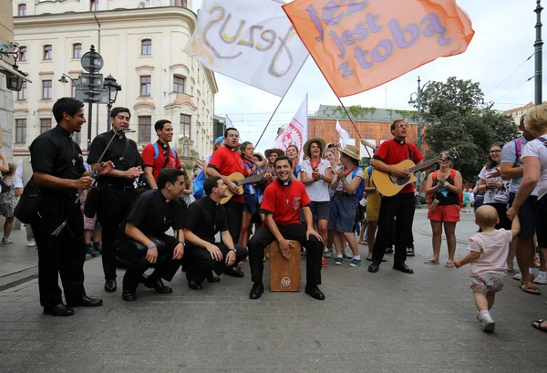 Pilgrims of World Youth Day sing and dance on the Main Square in  Cracow. Poland