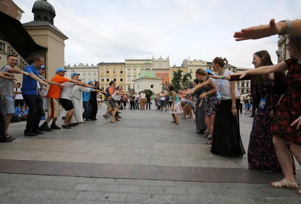 Pilgrims of World Youth Day sing and dance on the Main Square in  Cracow. Poland