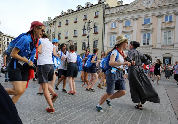 Pilgrims of World Youth Day sing and dance on the Main Square in  Cracow. Poland