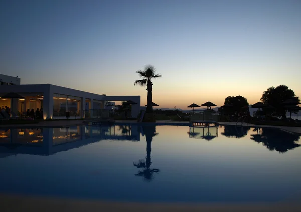 Swimming pool of luxury hotel at dusk