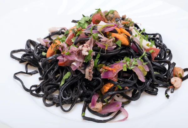 Black spaghetti with seafood and vegetables