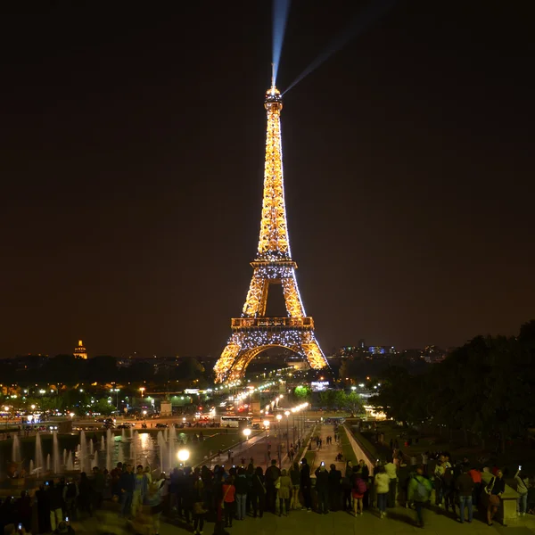 Eiffel Tower brightly illuminated at night in September in Paris. The Eiffel tower is the most visited monument of France.