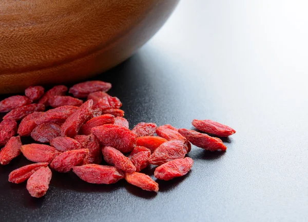 Heap of Dry Goji Berries on the Dark Table