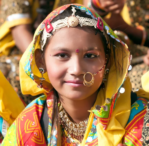 An unidentified girl  in colorful ethnic attire attends at the P