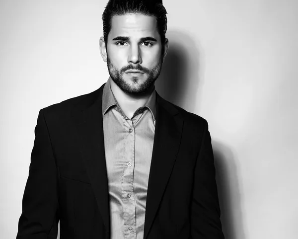 Handsome young man in suit on grey background