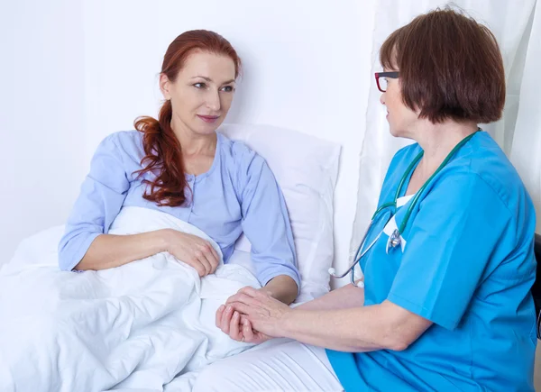 Female patient lying in hospital bed