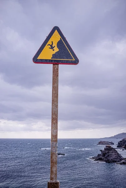 Warning sign on cliff