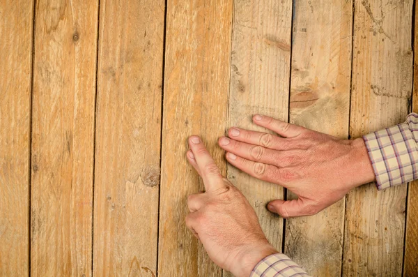Human hand on wooden background