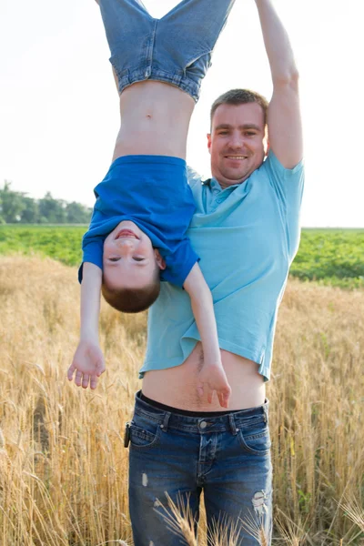 Father holding son upside down