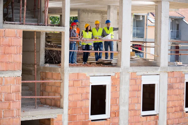 View of construction in progress with group of architects