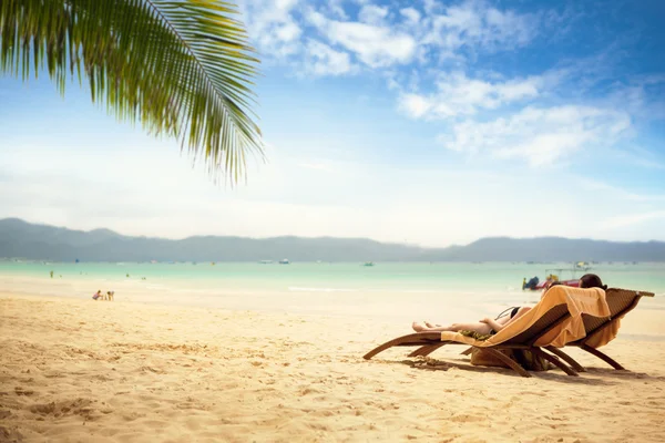 Two lounge chair at tropical beach