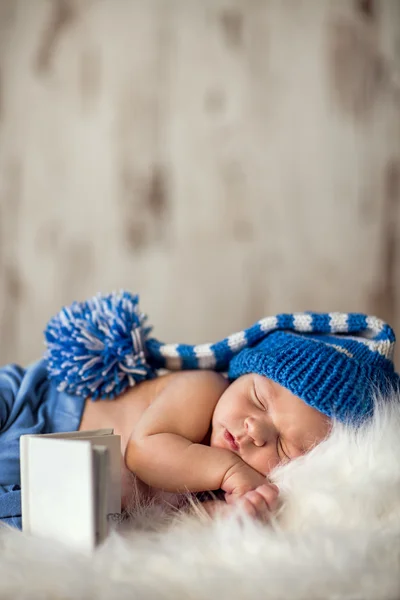 Newborn baby sleeps on a white blanket