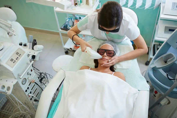 Woman having facial hair removal with laser