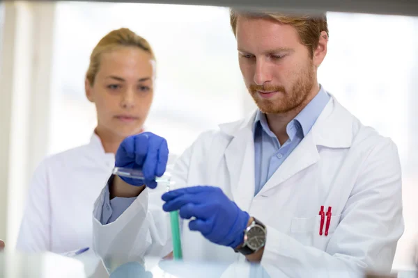 Chemist mixing liquids in lab