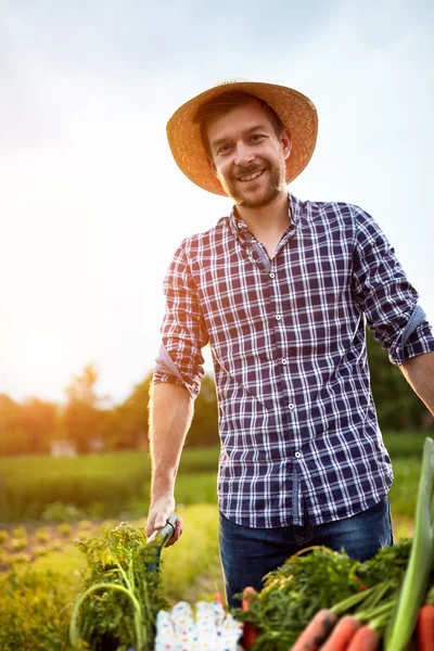 Young farmer with smile on work in garden