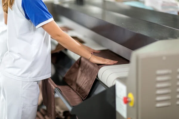 Woman ironing of machines