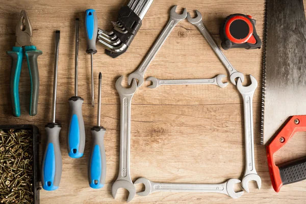 House of wrenches on wooden background