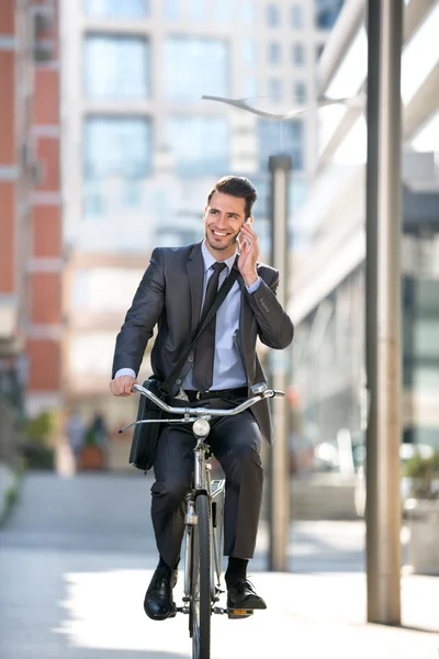 Full length of handsome men go to on work with bike