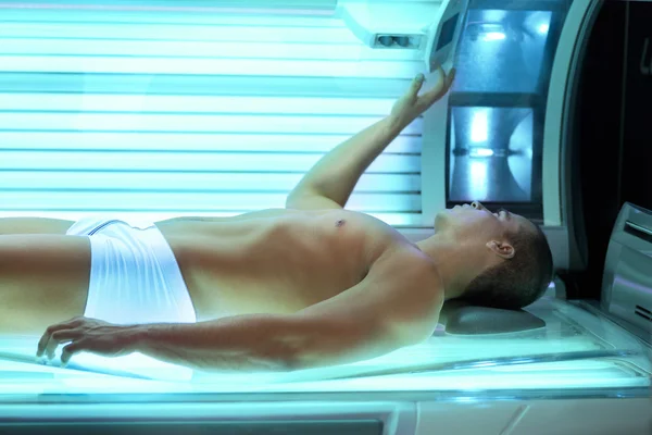 Young man relaxing during a tanning